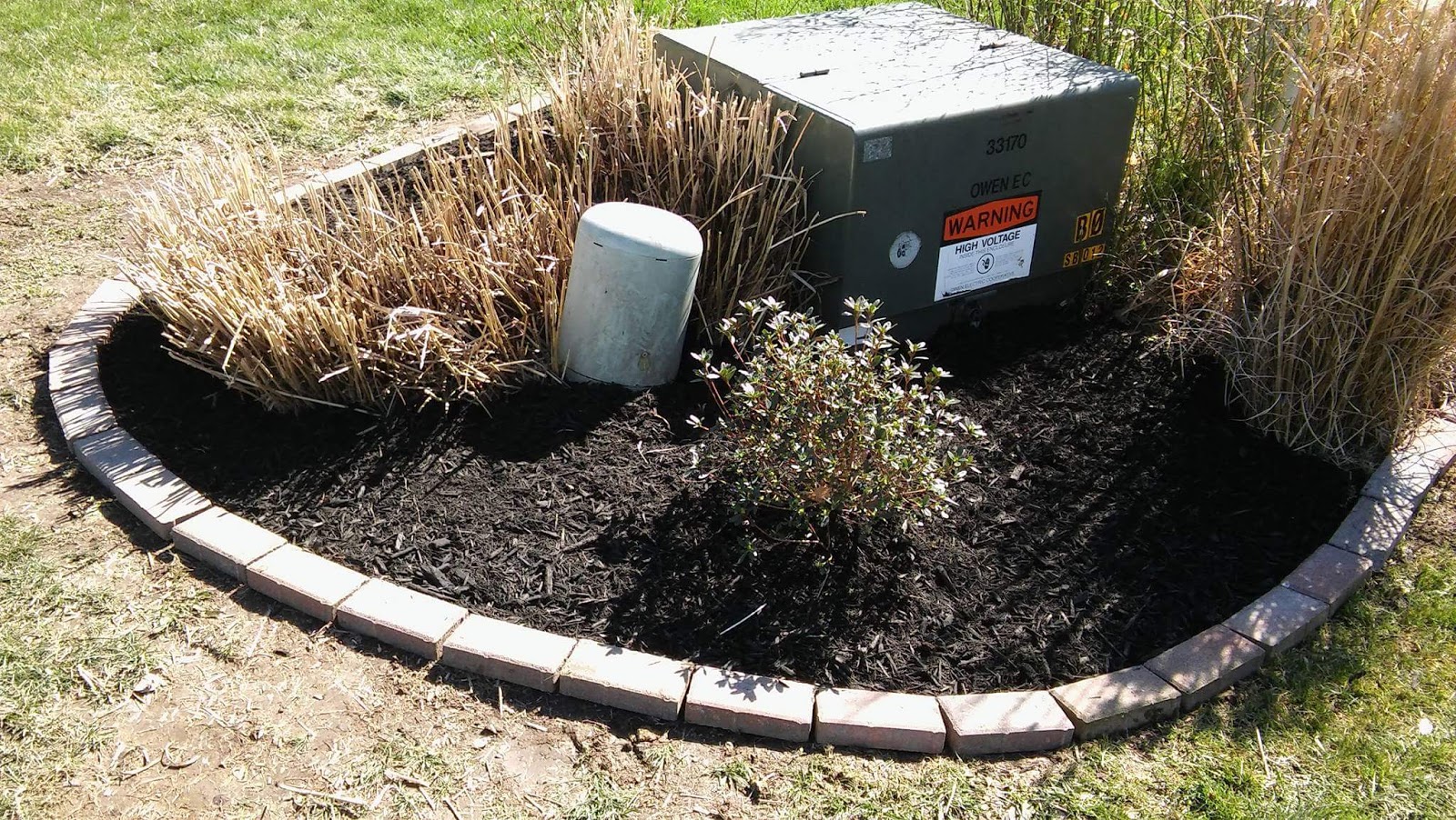 Fresh black mulch bed with clean brick edging